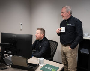 Ronan Dolan and Niall Mullan collaborating at a computer